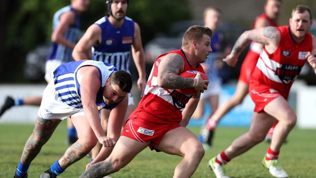 Jackson Freebairn of Lalor charges clear of a Reservoir opponent.