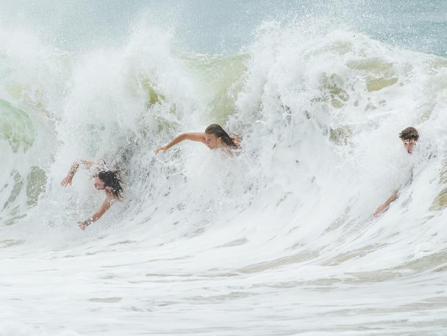 Body surfers fly down a wave at Moffat Beach. Strong winds and large swell has arrived on the Sunshine coast as Cyclone Oma continues to track towards South East Queensland. Photo Lachie Millard