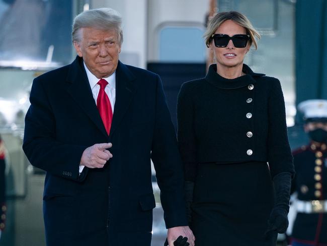 Outgoing US President Donald Trump and First Lady Melania Trump step out of Marine One at Joint Base Andrews in Maryland on January 20, 2021. - President Trump and the First Lady travel to their Mar-a-Lago golf club residence in Palm Beach, Florida, and will not attend the inauguration for President-elect Joe Biden. (Photo by ALEX EDELMAN / AFP)