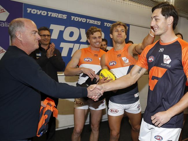 John Quinn presents Stein with his debut guernsey. Picture: Dylan Burns/AFL Photos via Getty Images