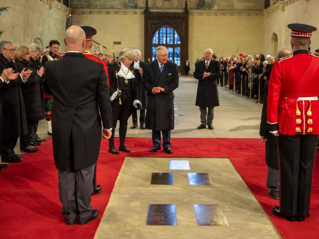 King Charles III looks at a new plaque installed in tribute to the late Queen at Westminster Hall. Picture: AFP