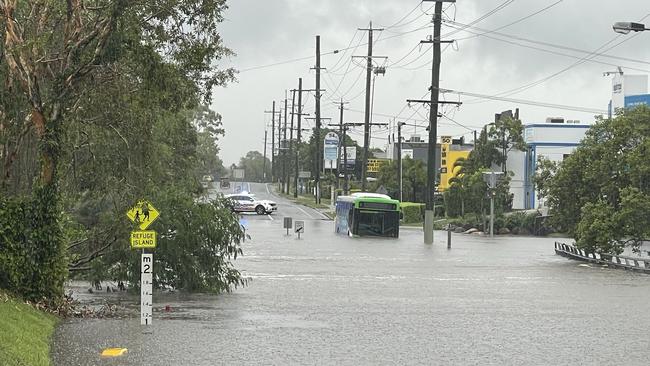 A bus has been swept up in flood waters on the Northern Gold Coast. Picture: Charlton Hart