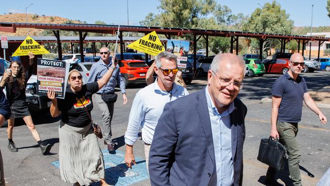 Prime Minister Scott Morrison is greeted by anti-fracking environmental protesters in Alice Springs on Sunday. Picture: Jason Edwards