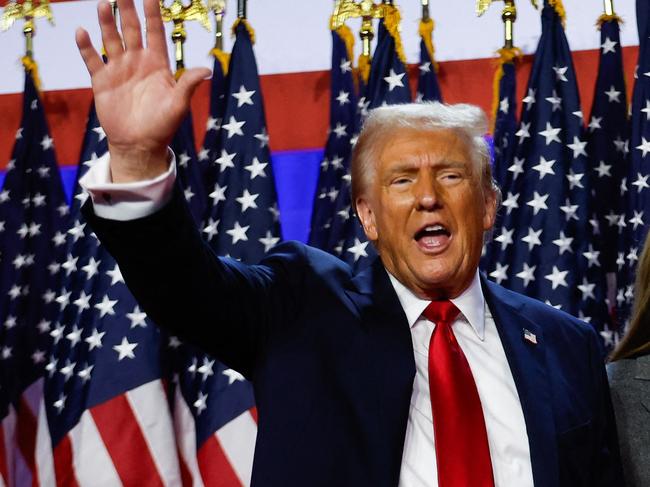 WEST PALM BEACH, FLORIDA - NOVEMBER 06: Republican presidential nominee, former U.S. President Donald Trump waves to supporters with former first lady Melania Trump and Barron Trump during an election night event at the Palm Beach Convention Center on November 06, 2024 in West Palm Beach, Florida. Americans cast their ballots today in the presidential race between Republican nominee former President Donald Trump and Vice President Kamala Harris, as well as multiple state elections that will determine the balance of power in Congress.   Chip Somodevilla/Getty Images/AFP (Photo by CHIP SOMODEVILLA / GETTY IMAGES NORTH AMERICA / Getty Images via AFP)