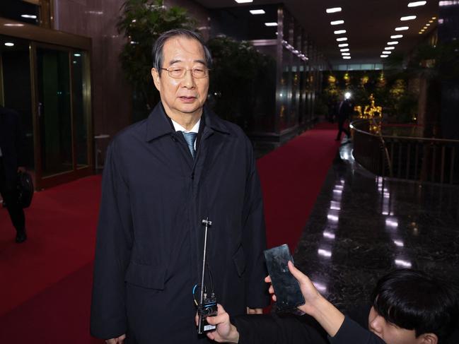 South Korea's Prime Minister Han Duck-soo speaks to reporters as he leaves the Government Complex in Seoul after his impeachment motion was passed by the National Assembly. Picture: Yonhap/AFP