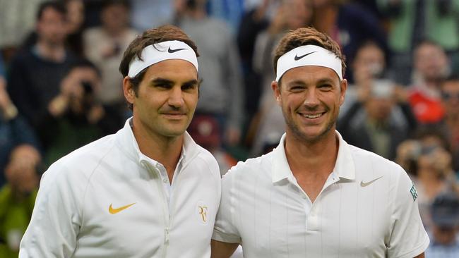 Britain's Marcus Willis (R) poses with opponent Switzerland's Roger Federer (L) at the start of their men's singles second round match.