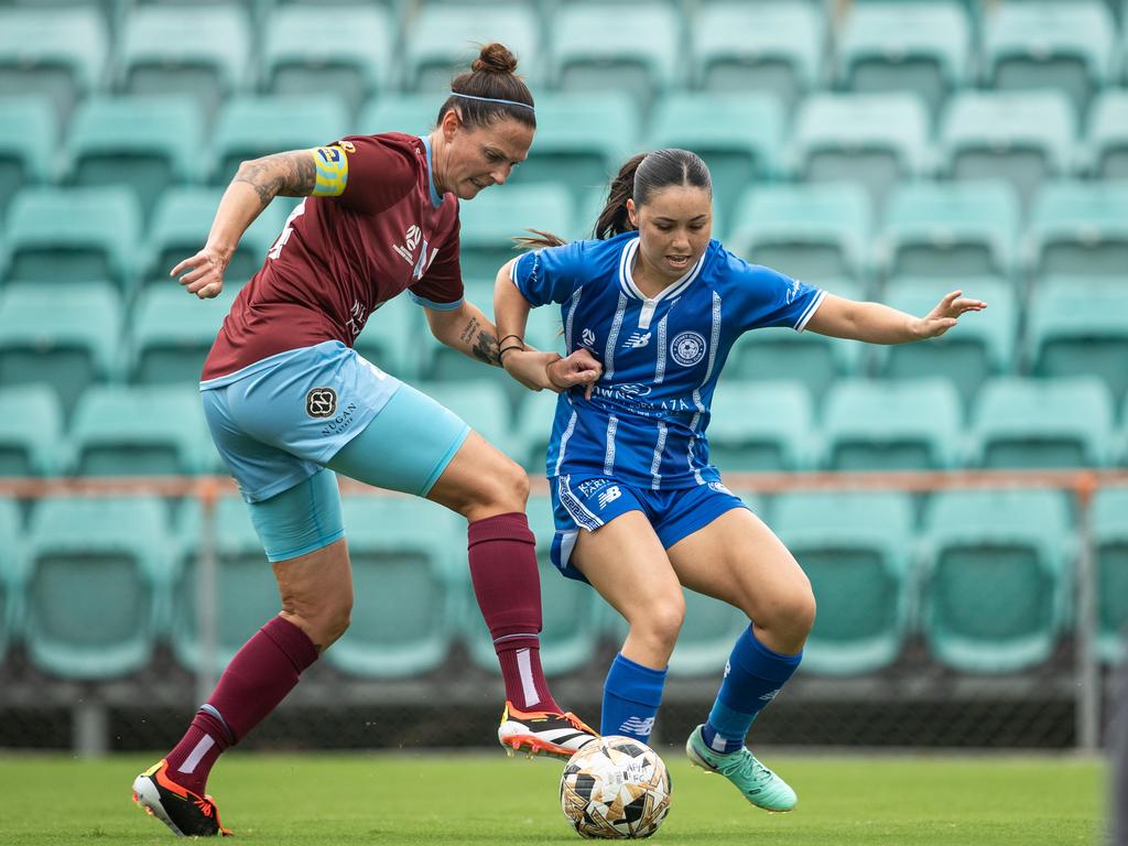 APIA captain Charlotte Young tackles Rochelle Borromeo. Picture: Julian Andrews