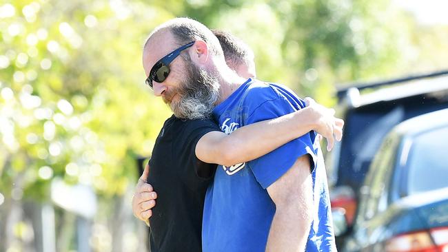 People comfort each other by the roadside at Image Flat Rd. Picture: Patrick Woods.