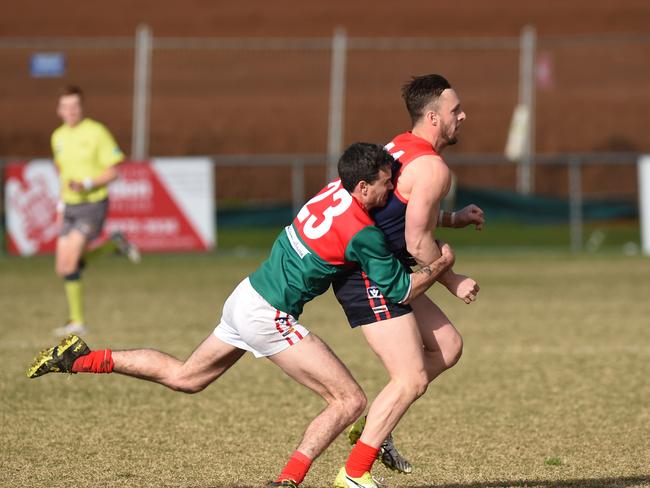 Pines defender Jack Fisher tackles Mt Eliza spearhead Justin Van Unen. Picture: Chris Eastman