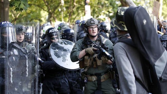 Police begin to clear demonstrators gather as they protest the death of George Floy, near the White House in Washington. Picture: AP