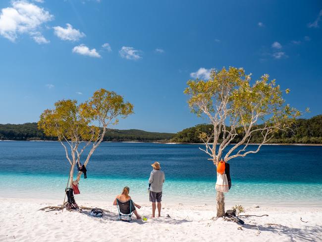 Aussies are being encouraged to book their domestic trips through travel agents. Picture above: Lake Mckenzie, Fraser Island, Queensland. Picture: Tourism Australia