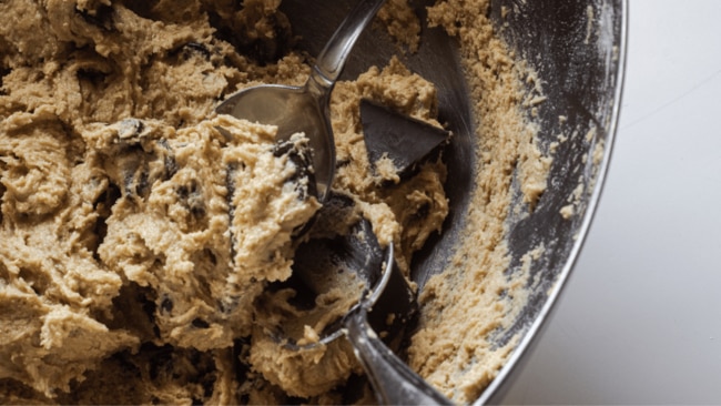 As tempting and delicious as it might be to sneak a taste during the baking process, easting raw cookie dough can be especially risky. Image: iStock