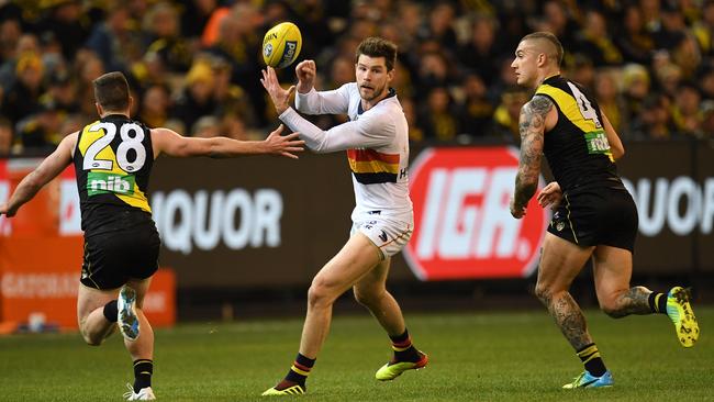 Bryce Gibbs of the Crows (centre) and Jack Higgins (left) and Dustin Martin of the Tigers  during the Round 16 match at the MCG. Picture: AAP Image/Julian Smith