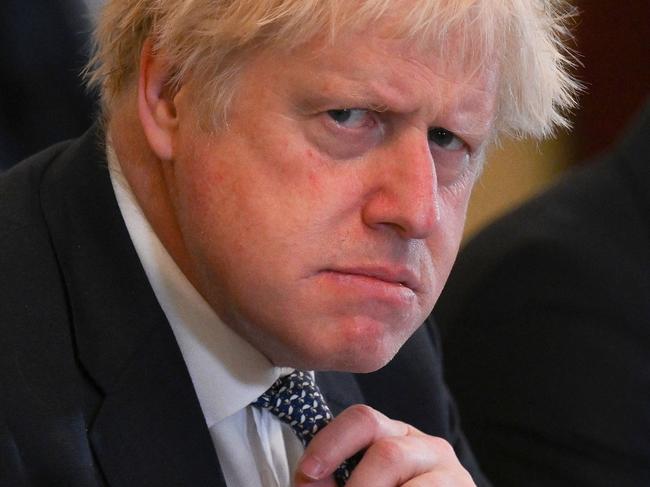 (FILES) In this file photo taken on May 24, 2022 Britain's Prime Minister Boris Johnson adjusts his tie at the start of a cabinet meeting at 10 Downing Street in London. - Boris Johnson will resign as Conservative party leader on July 7, 2022, the BBC reported, paving the way for a successor to replace him as British prime minister, after dozens of his ministers quit the government. (Photo by Daniel LEAL / POOL / AFP)