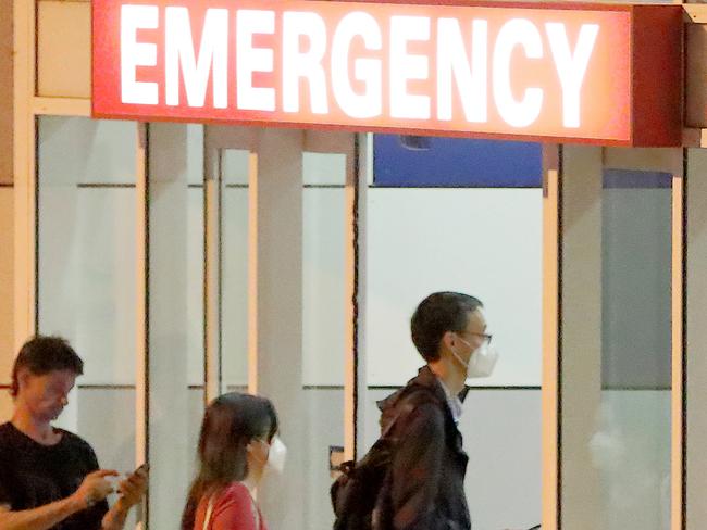 Two people wearing masks enter Westmead Hospital Emergency,  Sydney. 25th January, 2020. Picture by Damian Shaw / NO BYLINE PLEASE