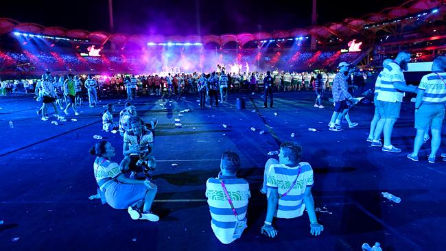 Bored athletes sit at the back of the stadium during the performances of the closing ceremony of the XXI Commonwealth Games on the Gold Coast. Picture: AAP