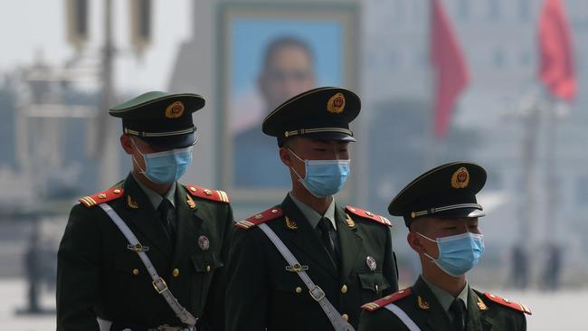 Paramilitary police officers on patrol in Beijing's Tiananmen Square on Friday. Picture: Greg Baker/AFP