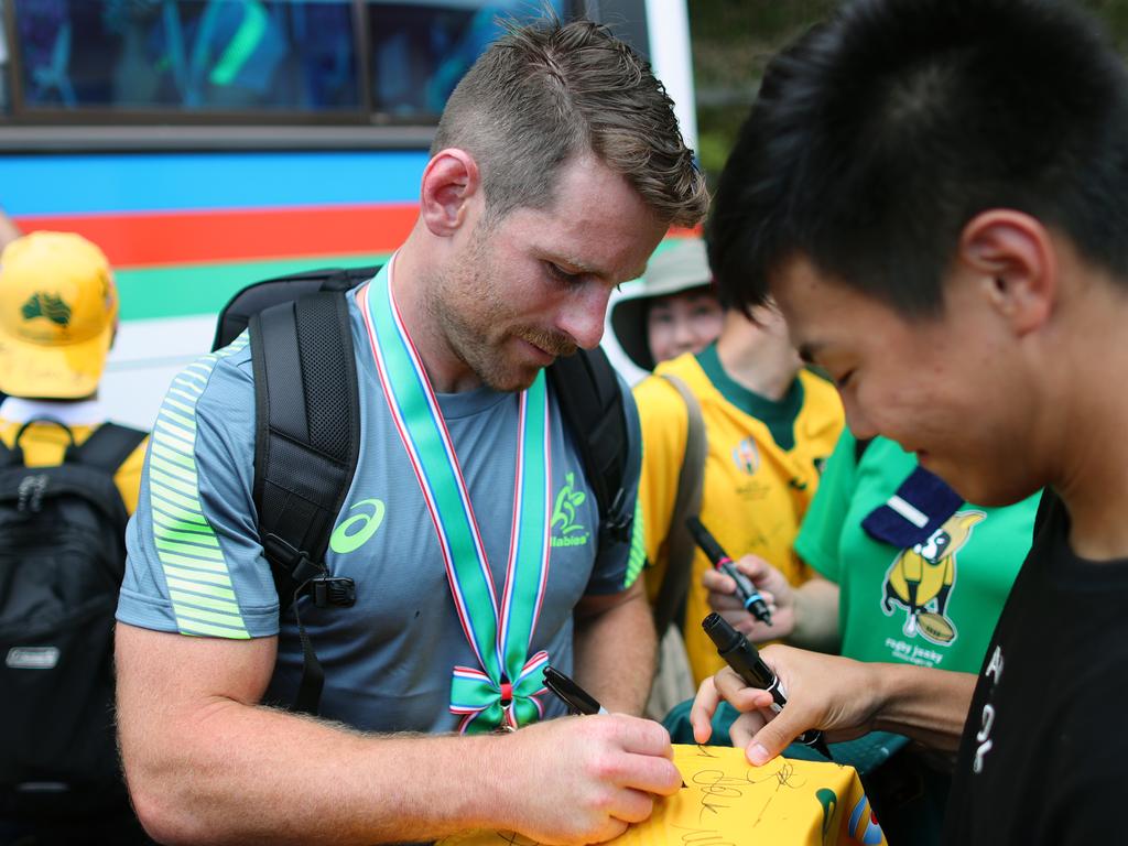 Bernard Foley signs autographs for locals following a Wallabies training session