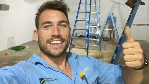 Elliot Mangan at work wiring up a store front, at the Kingaroy Shopping world.