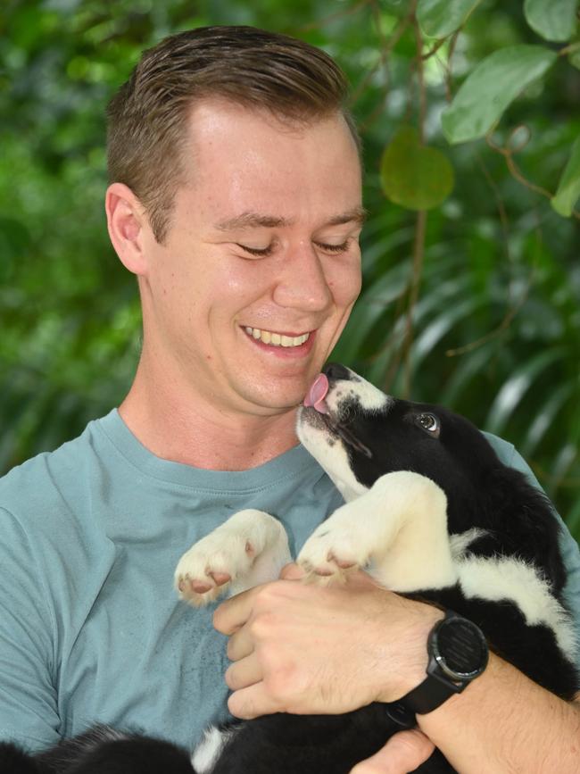 Border collie puppy Pippen is back safe in her loving owner Nathaniel Jackson’s arms. Picture: Julianne Osborne