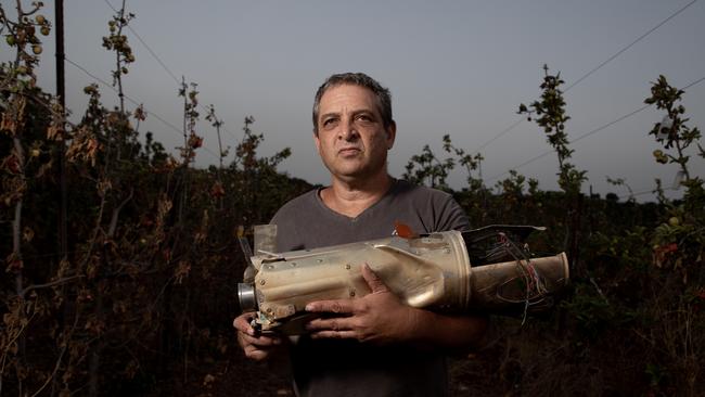 Shay Golany with an engine from a Russian 9M133 Kornet anti-tank guided missile found in a cherry field in his kibbutz in early July. Picture: Liam Mendes