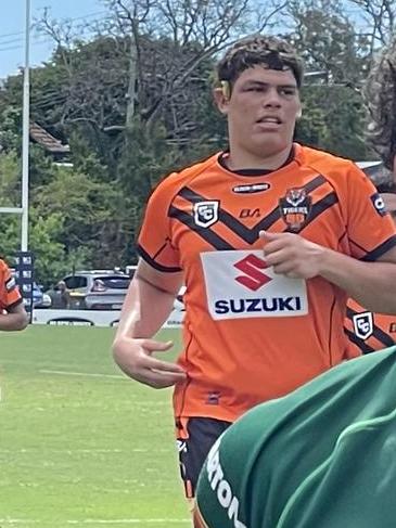 Kobi, in the background, leaves the field for Brisbane Tigers.