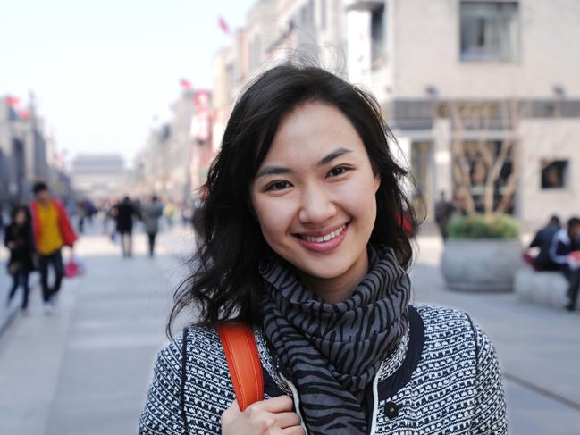 A happy asian woman shopping with shopping center background