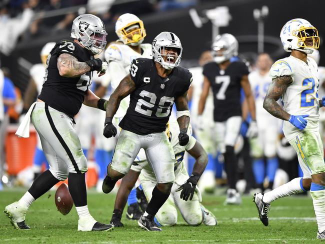 LAS VEGAS, NEVADA - JANUARY 09: Josh Jacobs #28 of the Las Vegas Raiders celebrates during overtime against the Los Angeles Chargers at Allegiant Stadium on January 09, 2022 in Las Vegas, Nevada. (Photo by Chris Unger/Getty Images)