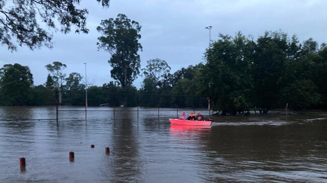 A Traffic and Highway Patrol officer commandeers a boat to rescue a woman at Belgenney Reserve, Camden. Picture: Traffic and Highway Patrol Command NSW Police