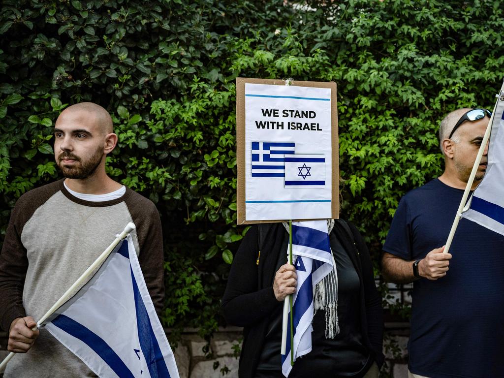 Demonstrators holding Israeli flags take part during a demonstration in support of Israel outside the Israeli Embassy in Athens. Picture: AFP