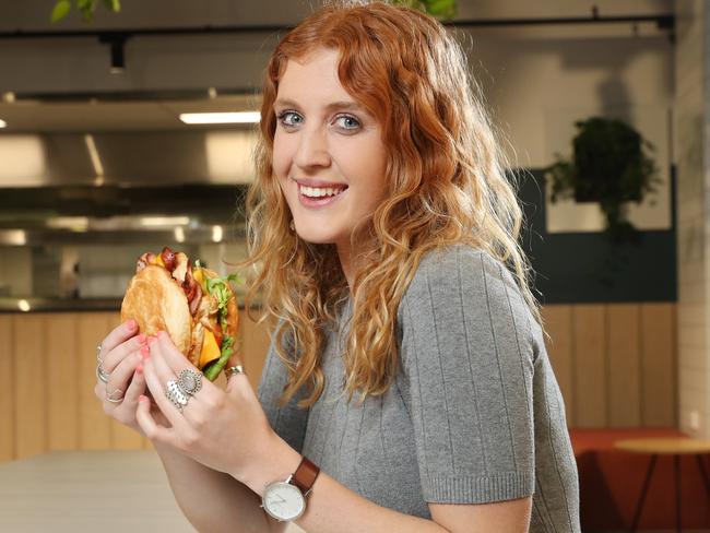 Meagan Sultana bites into the Big Knotty at the Village Green Hotel. Picture: Richard Dobson