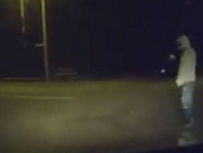 An image from the dashcam shows the hooded man waiting for the car to pull up.