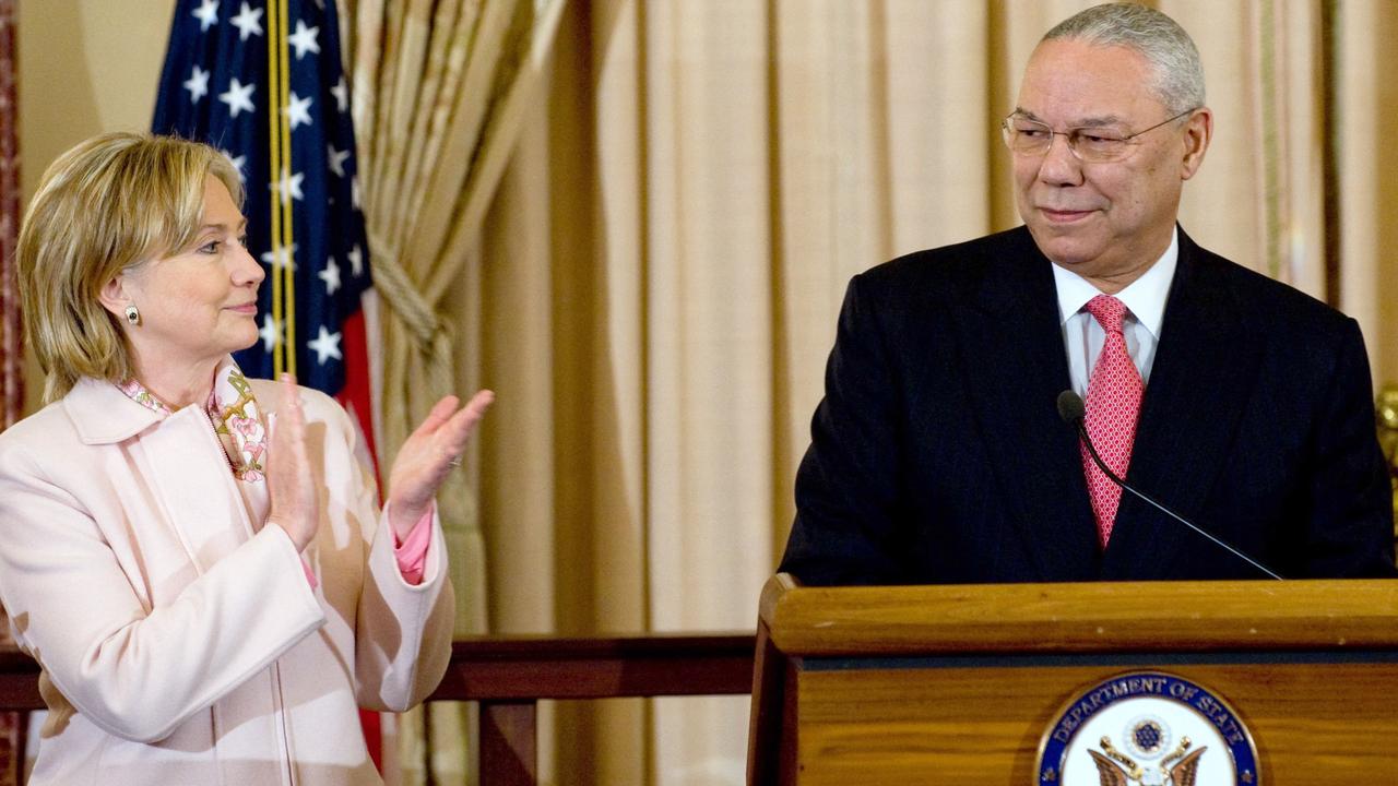 Former US Secretary of State Hillary Clinton applauds former US Secretary of State Colin Powell.