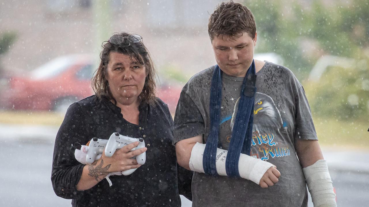 Beau Medcraft, who was also injured in the jumping castle tragedy, visits the memorial with his parents. Picture: Jason Edwards