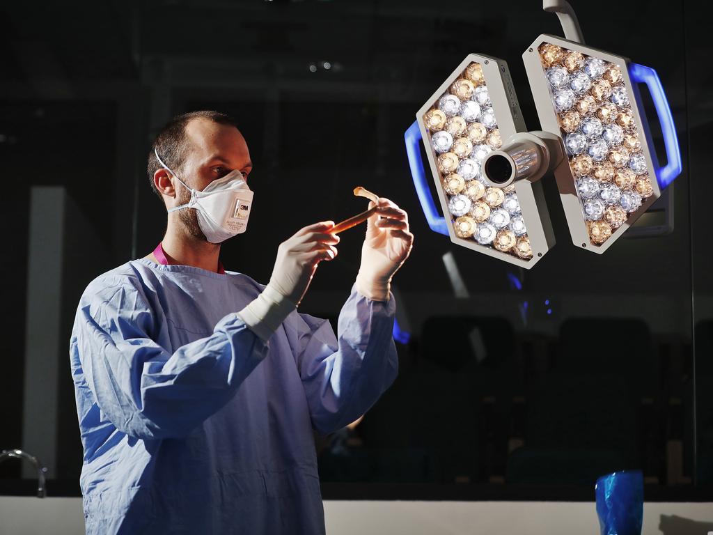 Dr Jack Garland, Forensic Pathologist at NSW Health Pathology Forensic and Analytical Science Service inspecting human remains. Picture: Sam Ruttyn