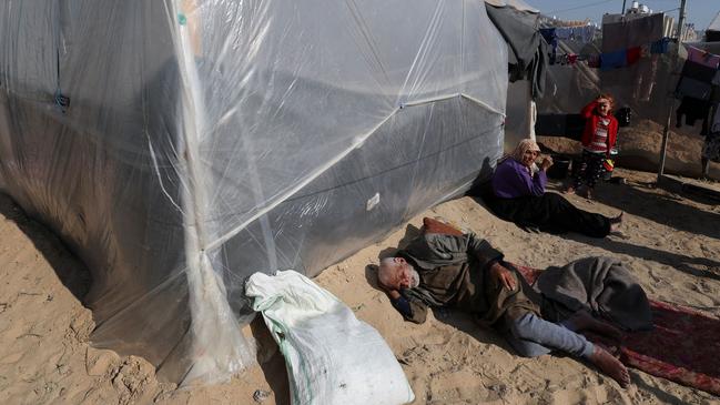 Displaced Palestinians, who fled their homes due to Israeli strikes, rest at a tent camp. Picture: Reuters/WSJ