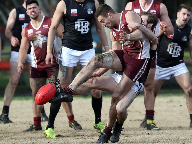 Ed Sim gets a kick away against East Burwood. Picture: Mark Dadswell/AAP