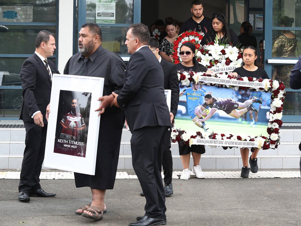 Photos of Titmuss and floral arrangements were spread across the church.