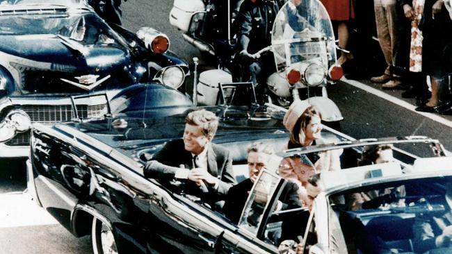 President John F Kennedy in the presidential limousine moments before his assassination. His wife Jacqueline is next to him and Texas Governor John Connally and his wife Nellie sit in front.