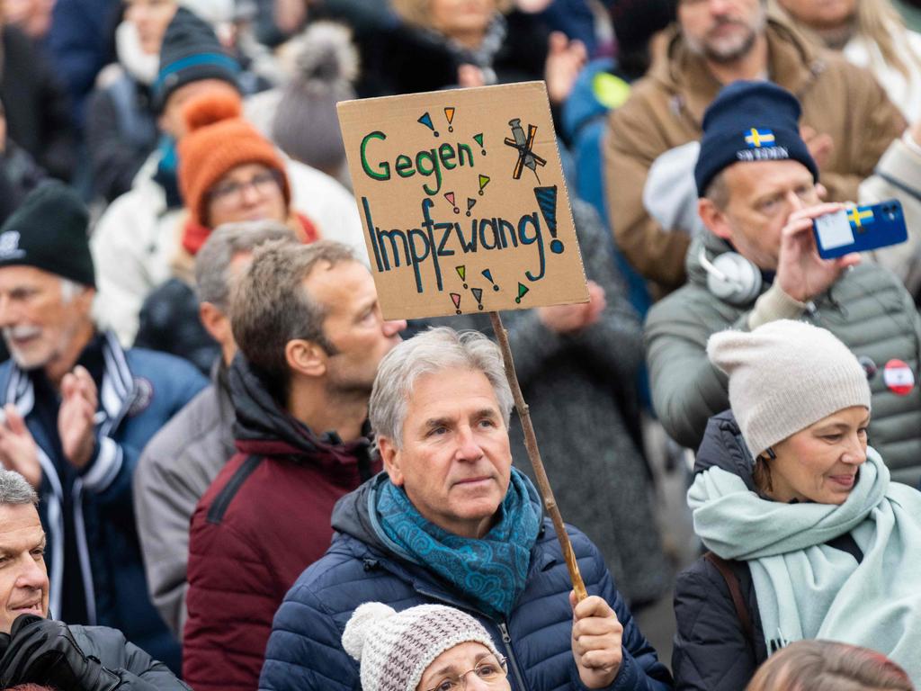 A demonstrator holds a sign reading ‘against compulsory vaccination’. Picture: Georg Hochmuth/APA/AFP