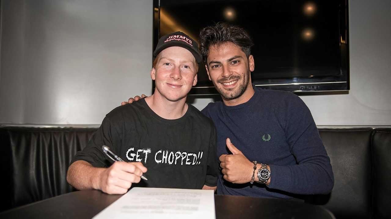 NEW DEAL: Toowoomba's Joel Kelso signs his contract with Leopard CIV team manager Alessandro Tonucci. Picture: Contributed