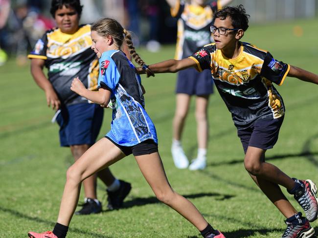 Ariana Janetzki of Middle Ridge State School attempts to evade Jahmahal Sedeek of Rockville State School in the inaugural Primary Interschools Reconciliation Touch Carnival hosted by Glenvale State School, Wednesday, May 28, 2025. Picture: Kevin Farmer