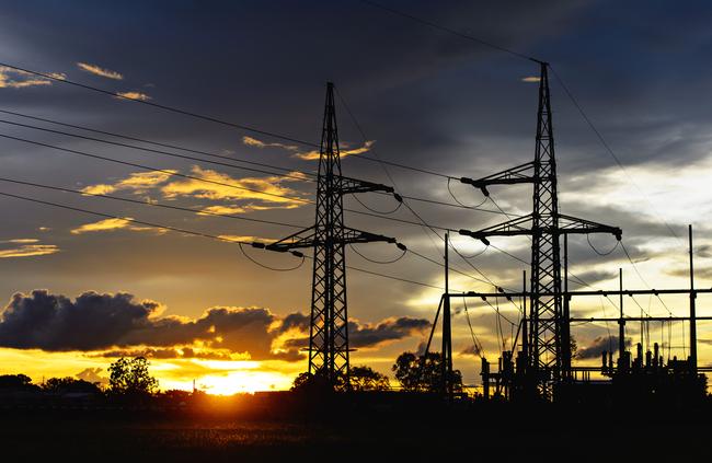 PowerWater electricity infrastructure and power lines at sunset.