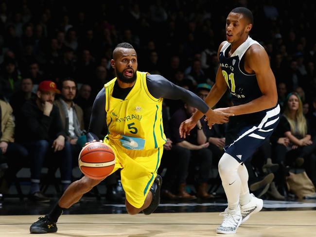 Patty Mills of the Boomers dribbles the ball past Stephen Domingo of the All-Stars