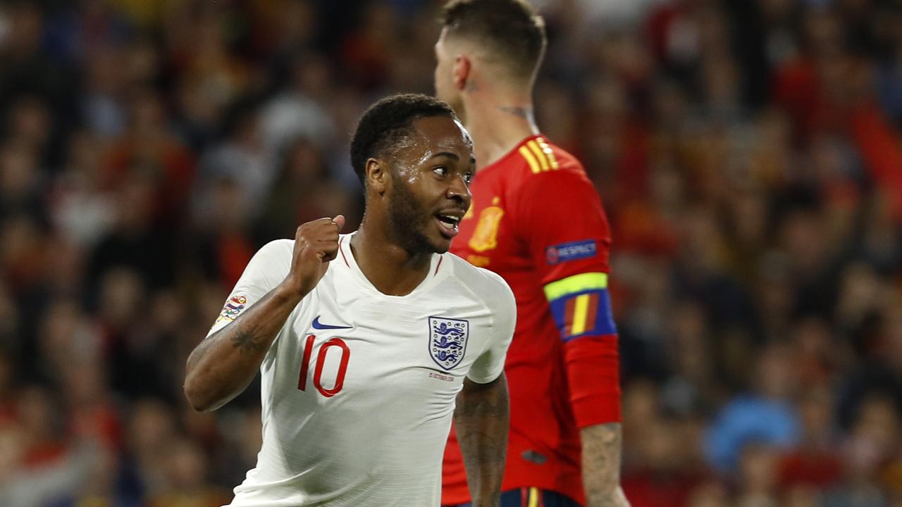 England's Raheem Sterling, left, celebrates after scoring his side's third goal against Spain