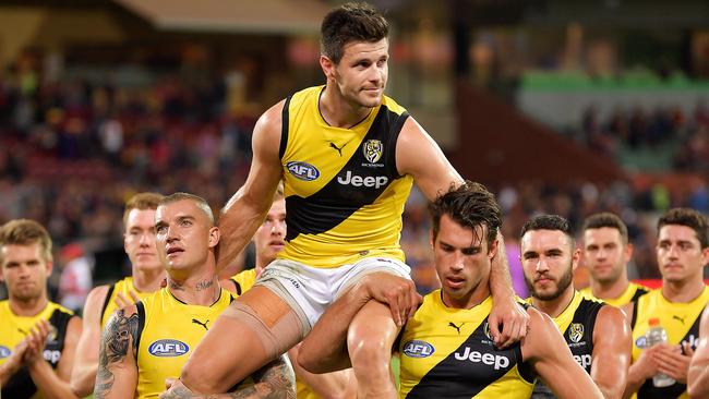 ADELAIDE, AUSTRALIA - MARCH 29: Trent Cotchin of the Tigers is chaired off the field by Dustin Martin of the Tigers and Alex Rance of the Tigers during the round two AFL match between the Adelaide Crows and the Richmond Tigers at Adelaide Oval on March 29, 2018 in Adelaide, Australia. (Photo by Daniel Kalisz/Getty Images)