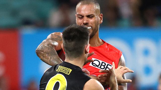 Sydney’s Lance Franklin lashes out at Richmond's Trent Cotchin on Friday night. Picture: Phil Hillyard