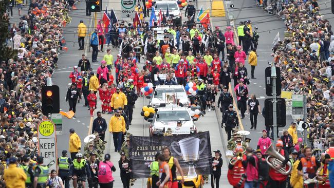 Thousands flock to the AFL Grand Final Parade in Melbourne every year.