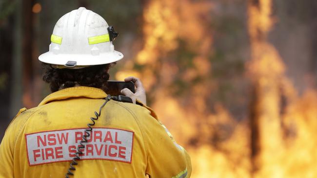 A firefighter monitors a controlled burn near Tomerong on the NSW South Coast on Wednesday. Picture: AP