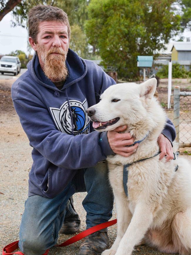 David Wallace, friend of Sean Ferris, with Buddy the dog – who was believed to be at the centre of issues that led to police attending Ferris’ home. Picture: Brenton Edwards